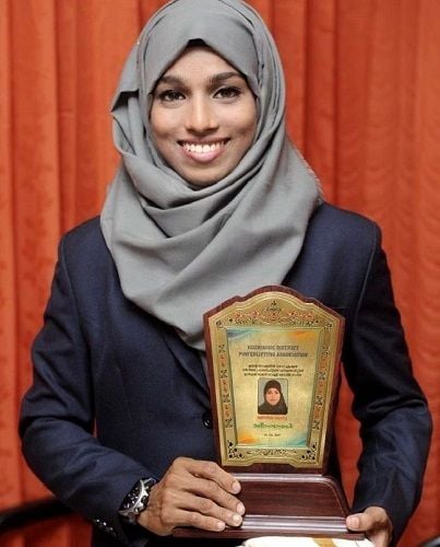 Majiziya Bhanu with her trophy won in the Kozhikode District Powerlifting Championship