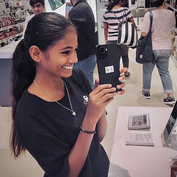 Maleesha Kharwa showing her new phone which she purchased herself