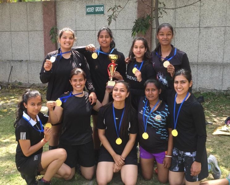 Malika Kaliraman (sitting, third from right) after winning the state-level tug-of-war competition in 2019