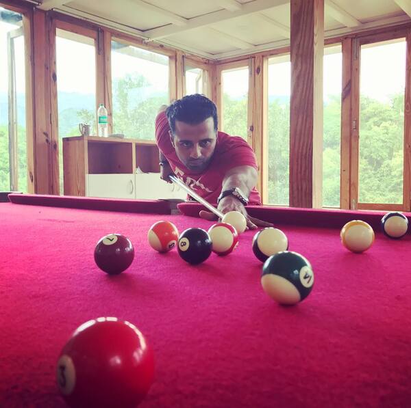 Manak Gupta playing a game of billiards