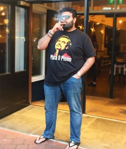 Mani Liaqat smoking a cigar