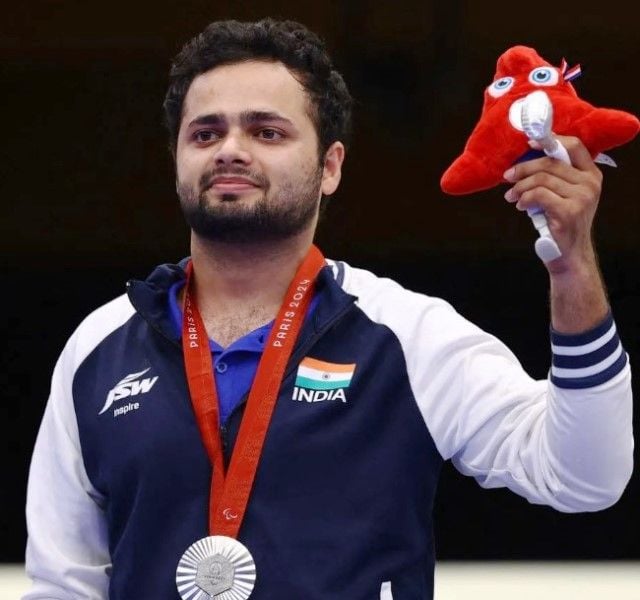 Manish posing for a photo with his silver medal