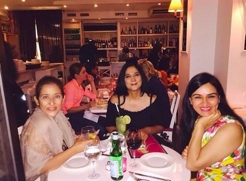 Manisha Koirala holding a glass of wine