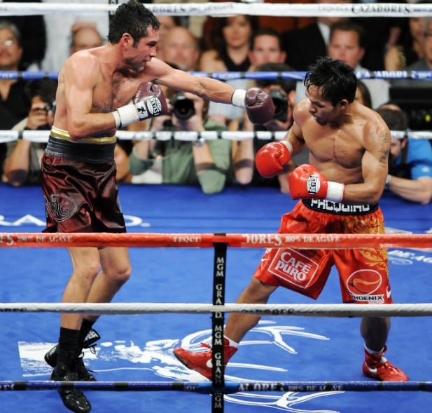 Manny Pacquiao during his fight against Oscar De La Hoya (left)