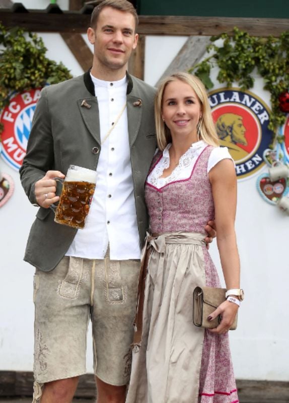 Manuel Neuer enjoying a mug of beer with Nina Weiss