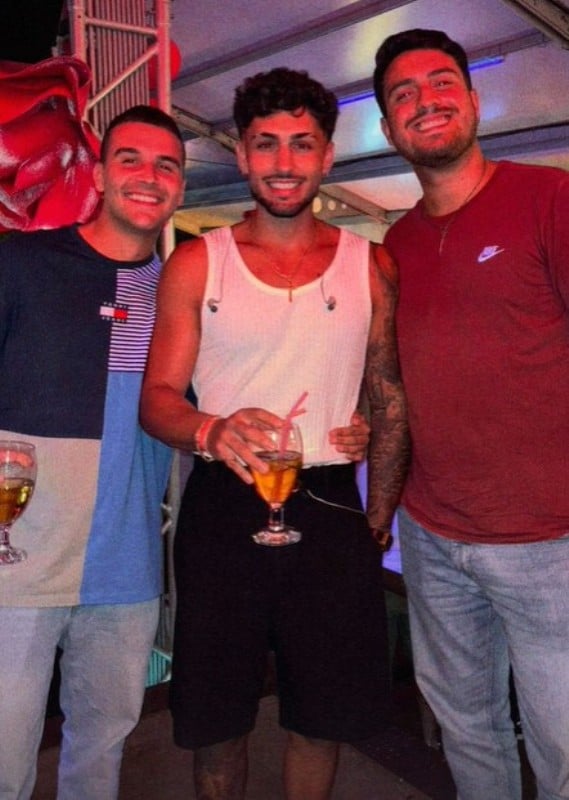 Manuel Vulcán (centre) holding an alcoholic beverage