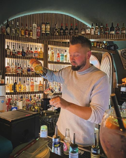 Marcel Schiefelbein pouring alcohol into a glass