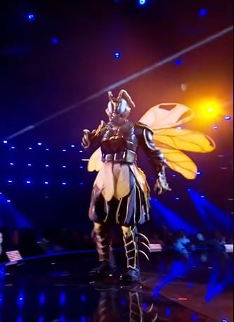 Mario performing on The Masked Singer as the Wasp