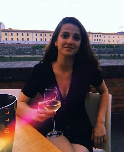 Marisa Abela holding a glass of alcohol