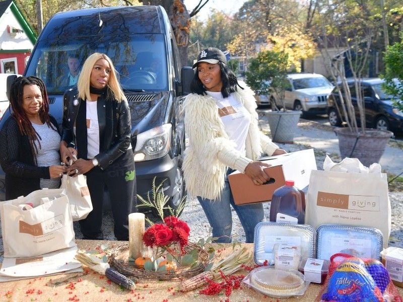 Marlo Hampton distributing necessities during her Simply Giving charity event