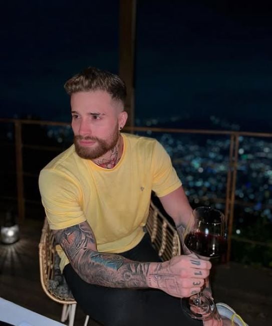 Mateo Varela holding a glass of alcohol