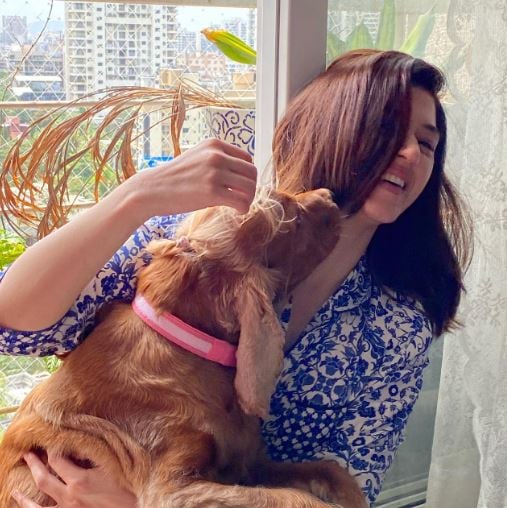 Mehreen Pirzadaa posing with a dog