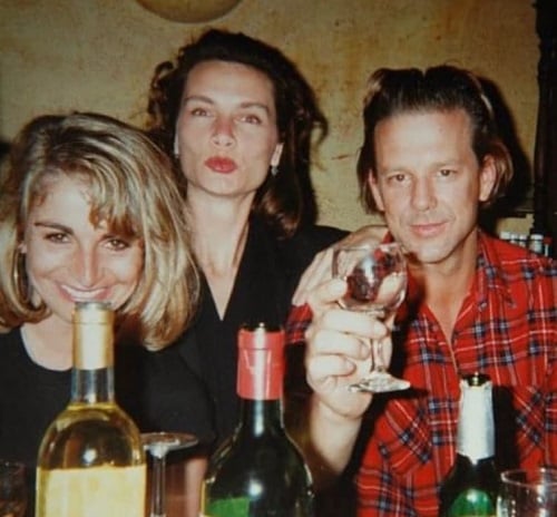 Mickey Rourke holding a glass of alcohol