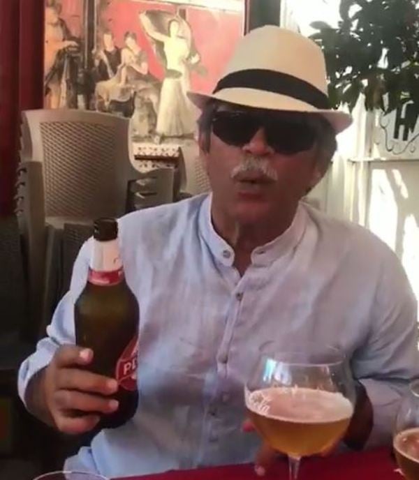 Micky Makhija holding a bottle of beer