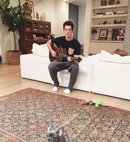 Miles Teller playing guitar
