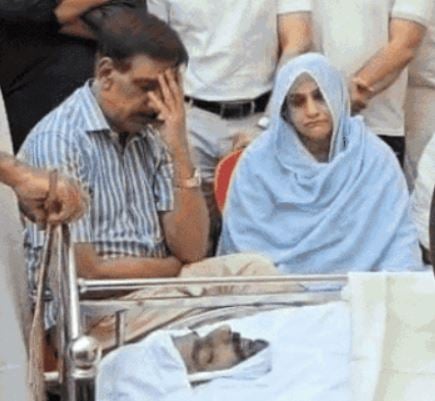 Mohammad Mustafa and his wife, while mourning in front of his son