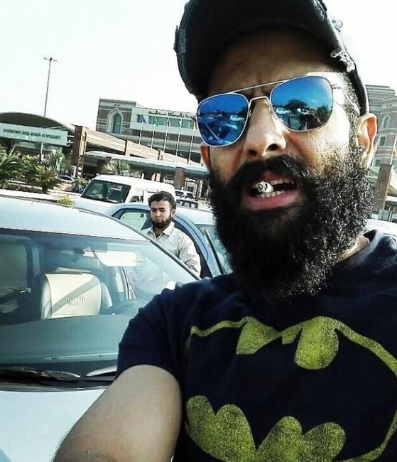 Mohib Mirza holding a cigarette in his mouth