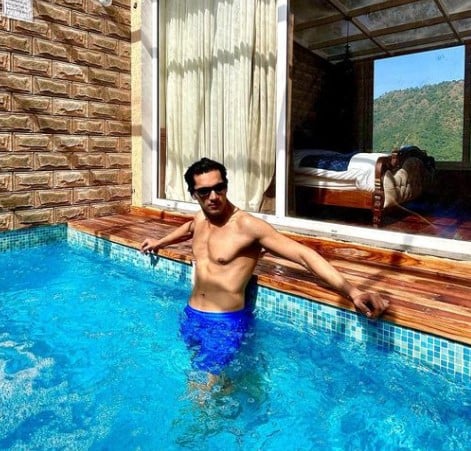 Mohit Duseja posing in a swimming pool