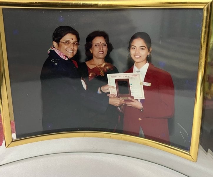 Mudra Gairola while receiving an award from Kiran Bedi during her school days