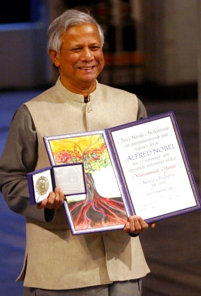 Muhammad Yunus posing with his Nobel Prize