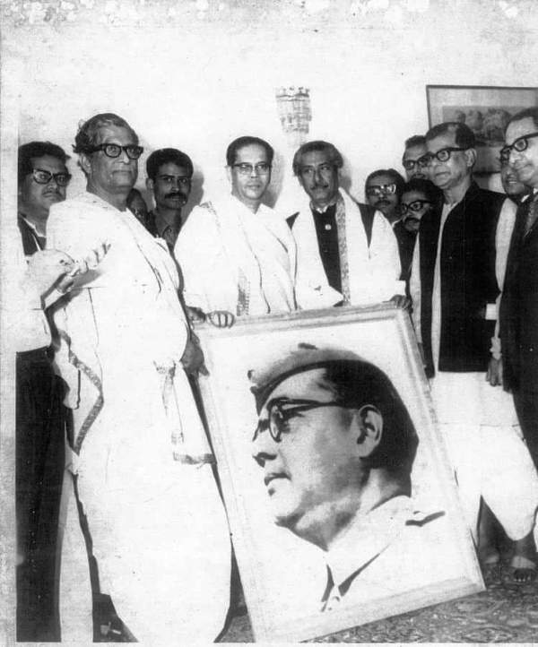 Mujibur Rahman holding a portrait of Netaji