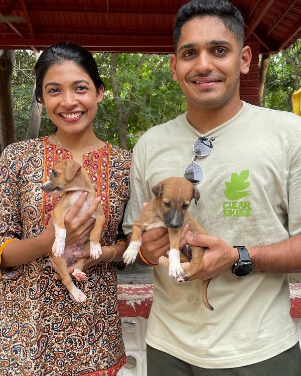 Nabha Gaddamwar and her husband, Tushar Deshpande, playing with dogs