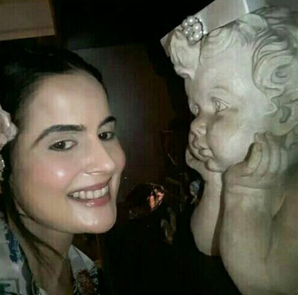 Nandini Singh with an Angel statue