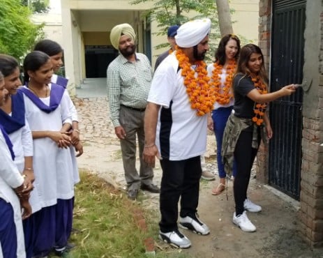 Nav Bhatia and his daughter while laying the foundation of washrooms for girls in Punjab