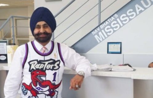 Nav Bhatia while wearing the jersey of Toronto Raptors