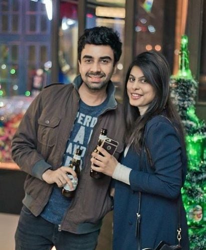 Naveen Kasturia holding a bottle of beer