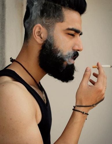 Naveen Pandit smoking a cigarette