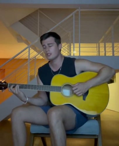 Nicholas Galitzine playing guitar