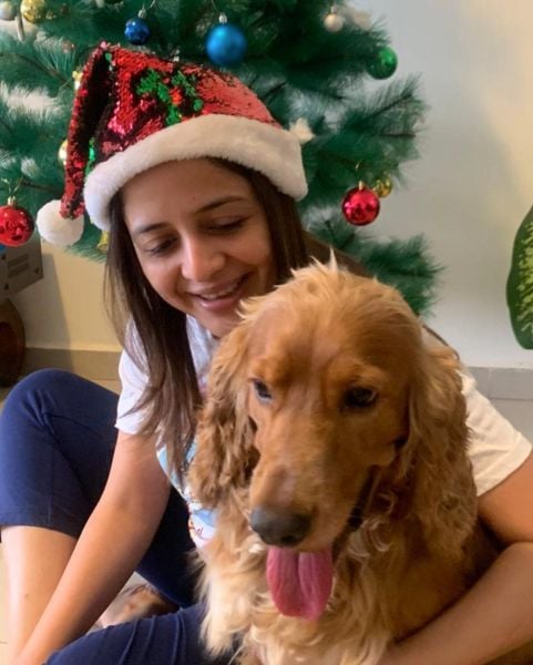 Nisha Poddar posing with her pet dog