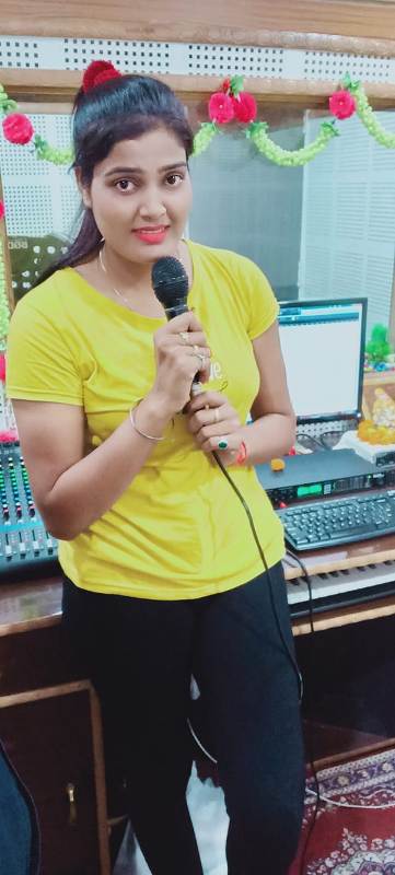 Nisha Upadhyay recording in a studio