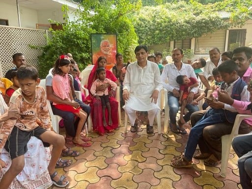 Nityanand Rai posing with his adopted children and their parents