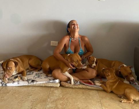 Niurka Marcos playing with her pet dogs