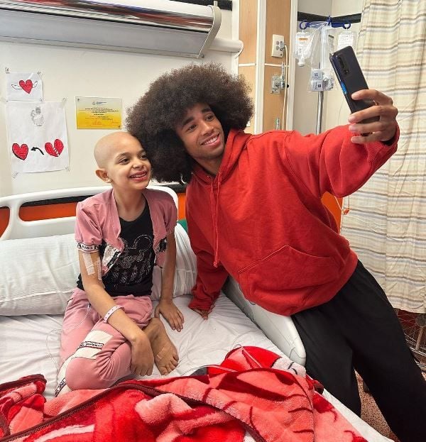 Noel Robinson (right) with a cancer patient