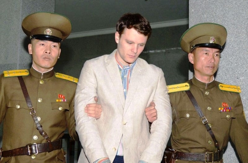 North Korean soldiers escorting Otto Warmbier to a prison