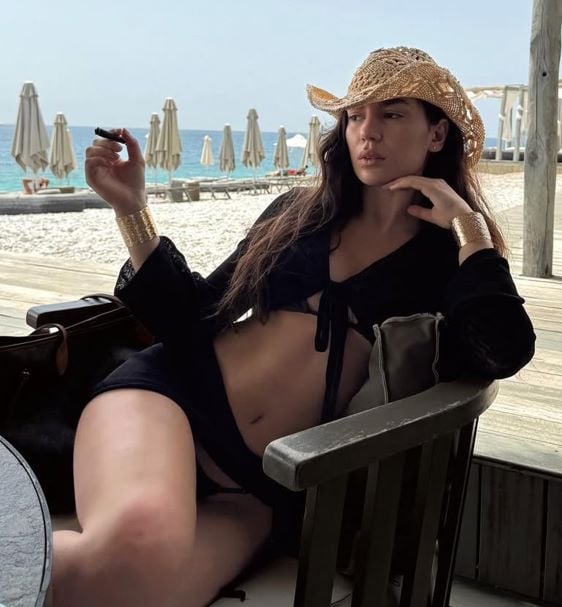 Ola Zenelaj holding a cigar