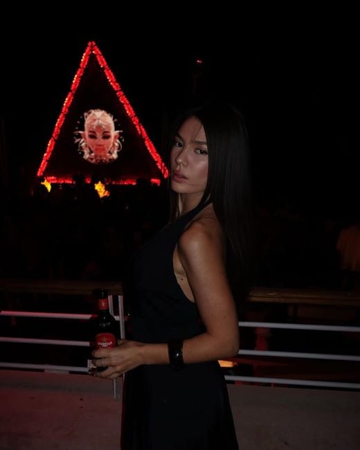 Ola Zenelaj holding a bottle of beer