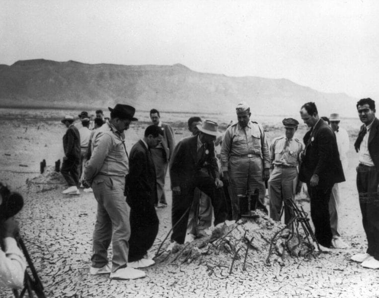Oppenheimer along with the staff involved in Project Manhattan inspecting the site where the blast took place