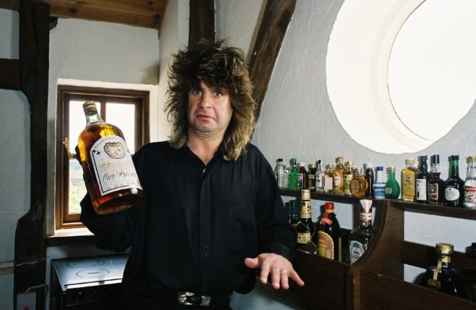 Ozzy Osbourne while showing his alcohol collection