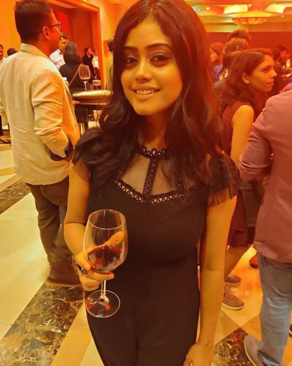 Parampara Tandon while holding a glass of red wine