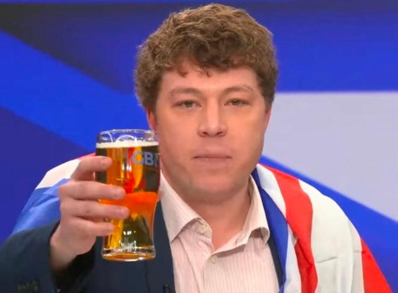 Patrick Christys drinking beer