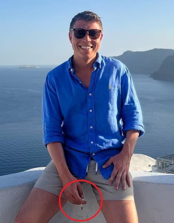 Patrick Christys holding a cigarette in his hand