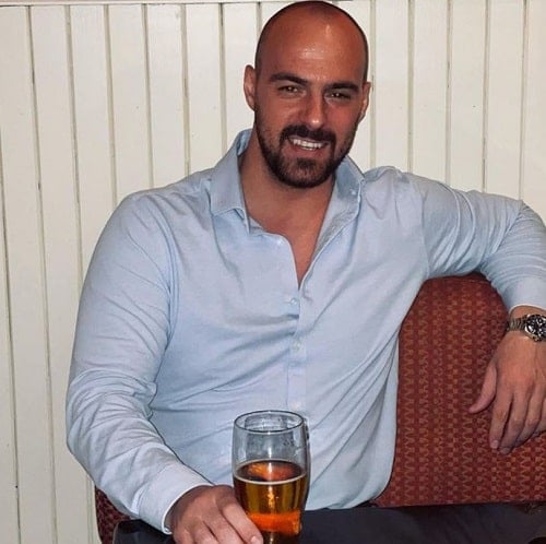 Paul Morina holding a glass of alcohol