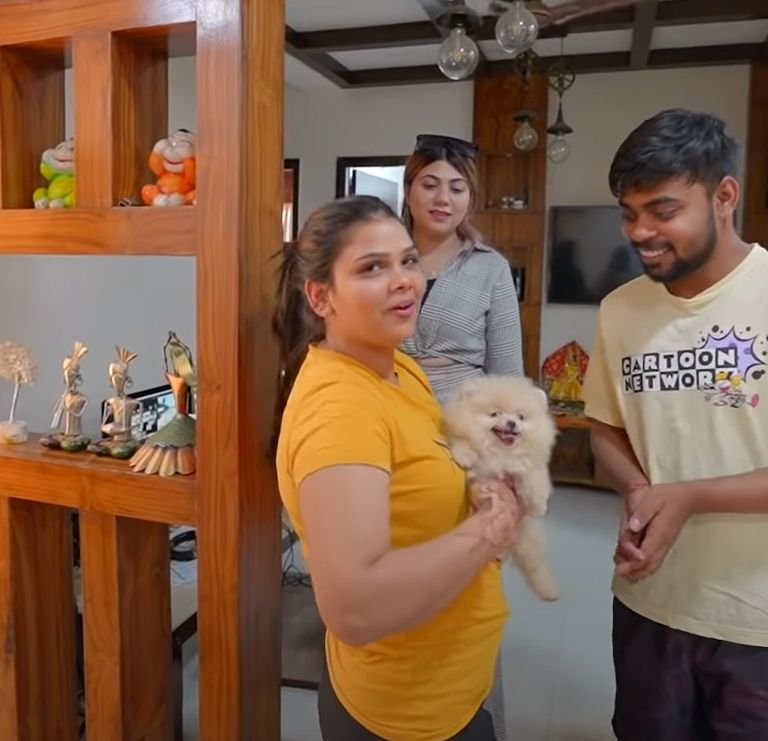 Payal Malik holding her toy pomenerian dog