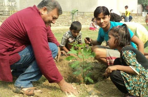Peepal Baba while planting a tree with children