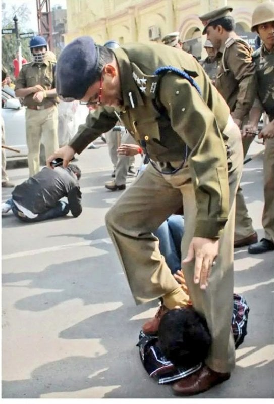 Photo of the incident in which DIG is rubbing his shoes on Anand Bhadauriya