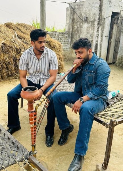 Piyush Gujjar (right) smoking hookah